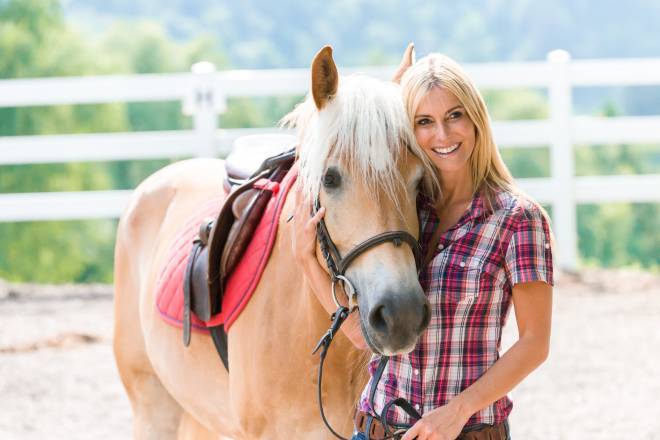Frau posiert mit einem Pferd