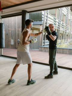 Mann beim Boxen mit Coach