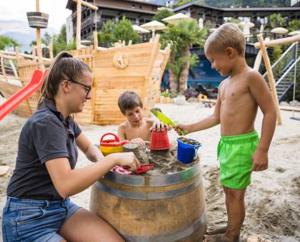 Kinder spielen mit Sand und Wasser
