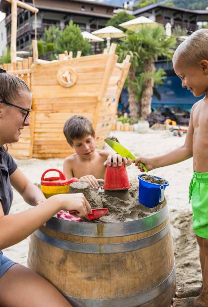 Kinder spielen mit Sand und Wasser
