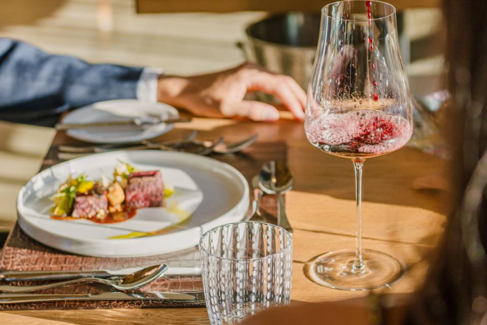 Mann bekommt Wein eingeschenkt